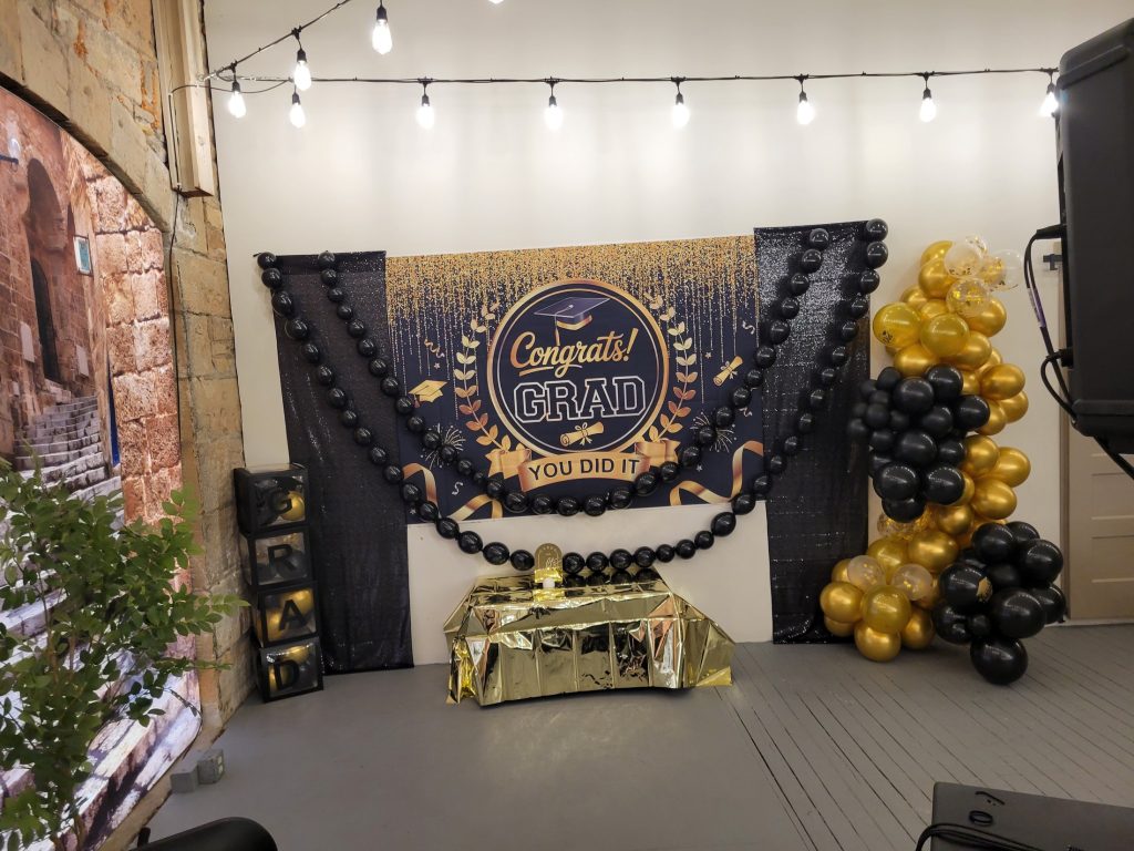 Graduation · black and gold, brick venue · 8 May 2026
